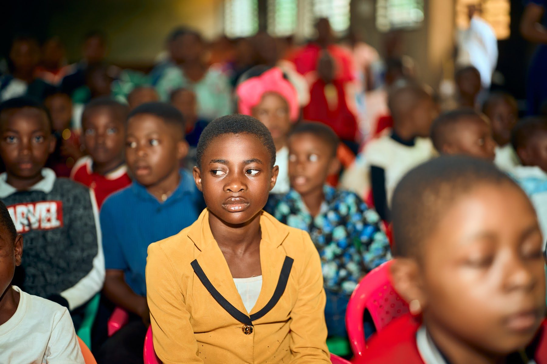 Children and teenagers seated among the congregation