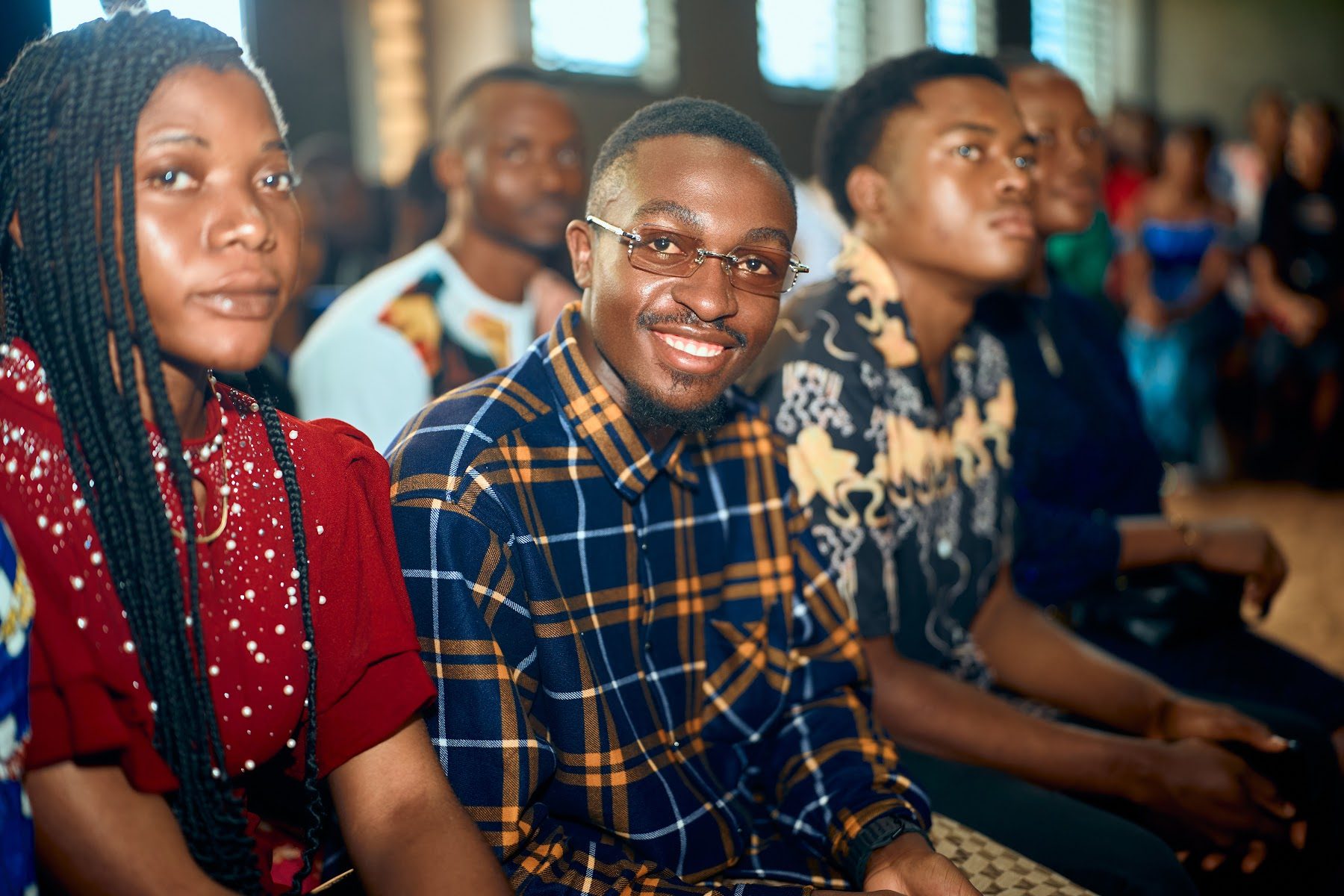 Smiling members of the congregation seated together during the service
