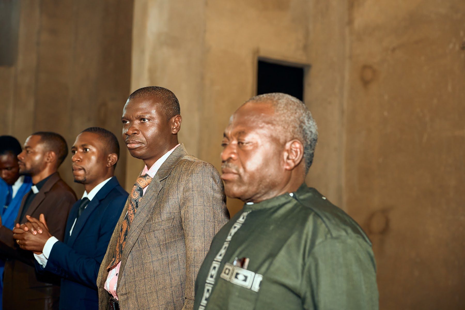 Church elders standing in worship