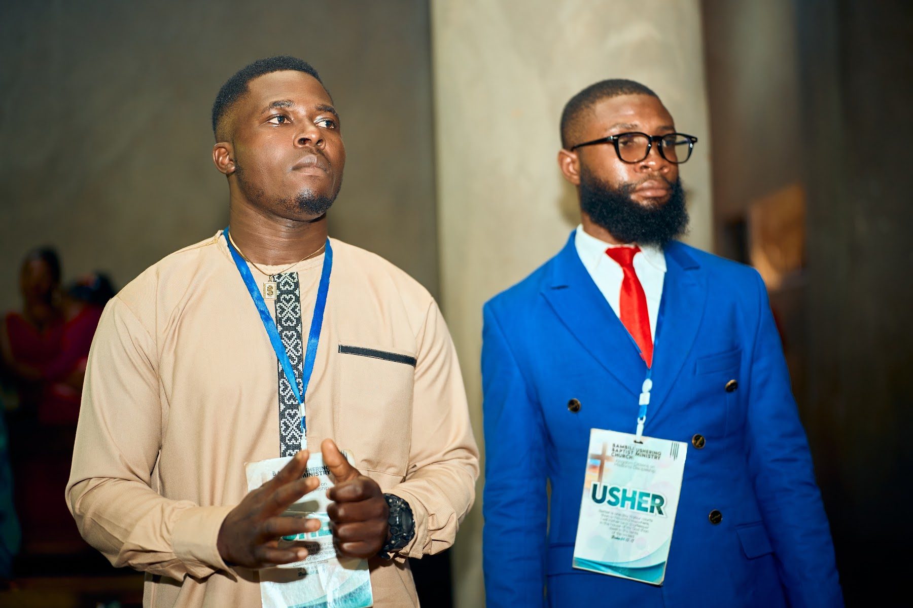 Two ushers standing at the front of the sanctuary